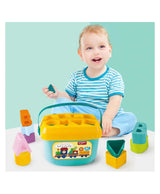 Smiling toddler playing with early learning letter shape sorting bucket and colorful ABC blocks
