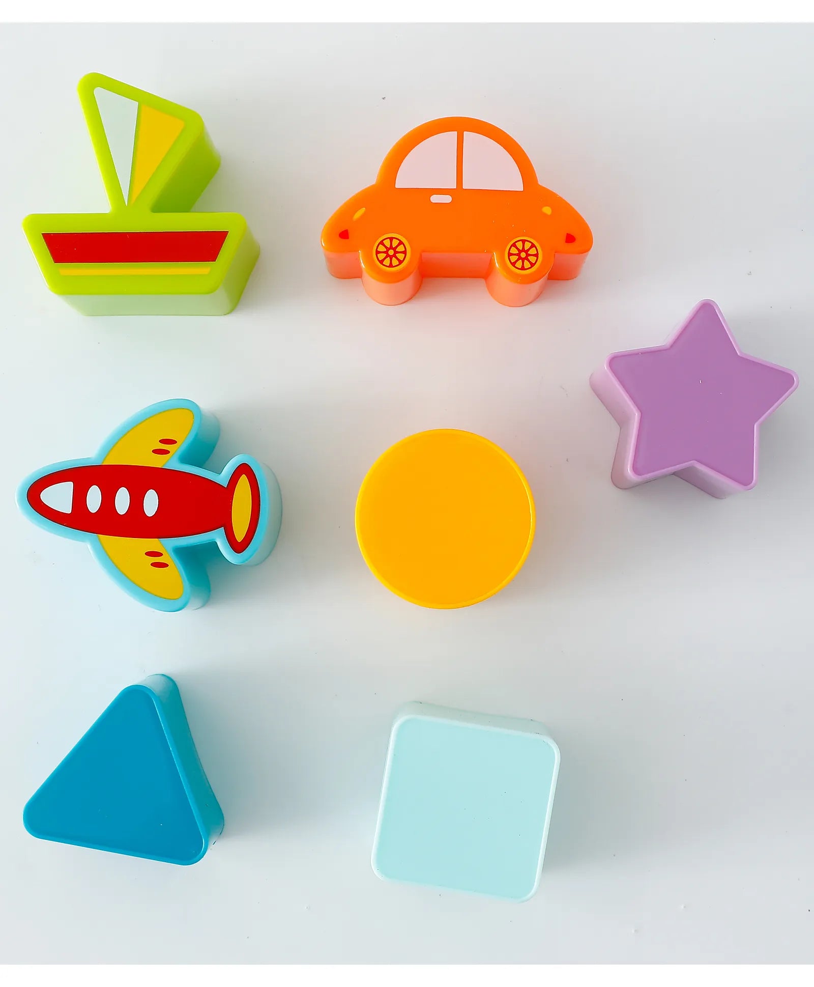 Colorful assorted shape blocks including star car boat airplane circle square and triangle for toy bus