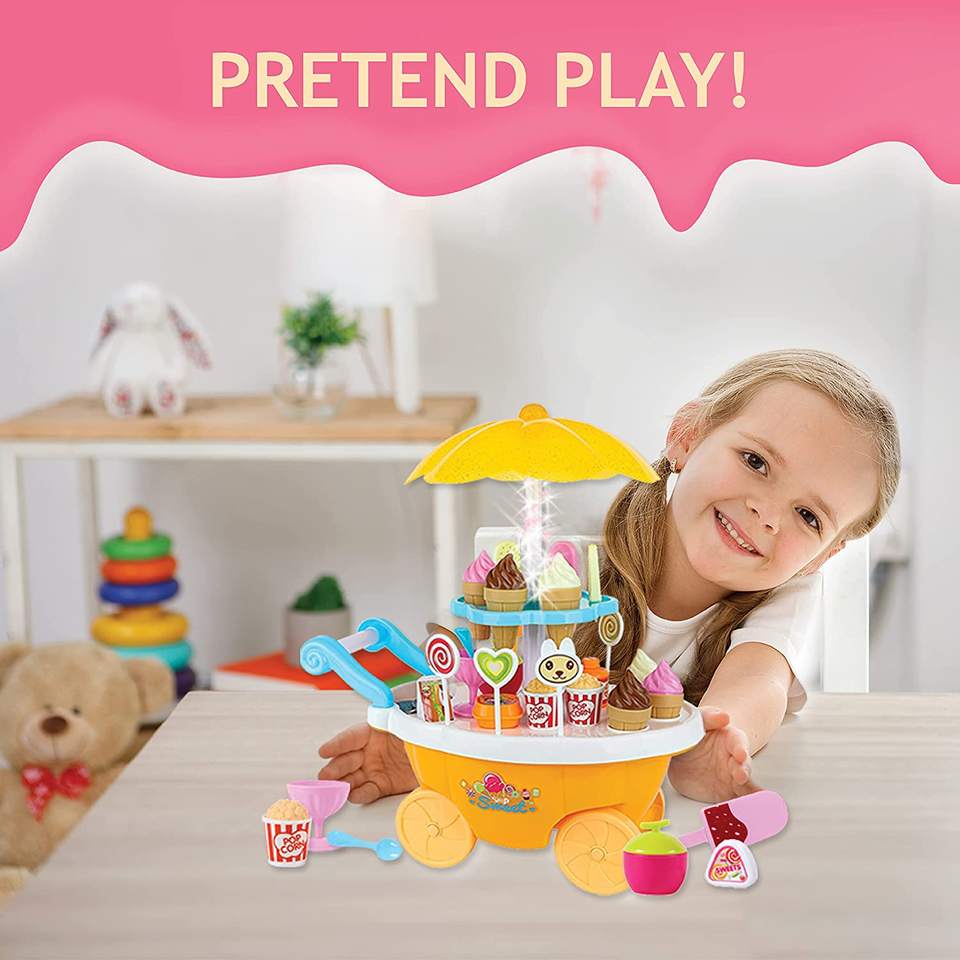 Smiling child playing with kids sweet ice cream cart play set featuring toy ice creams, lollipops, cones, and pretend shop accessories for fun learning