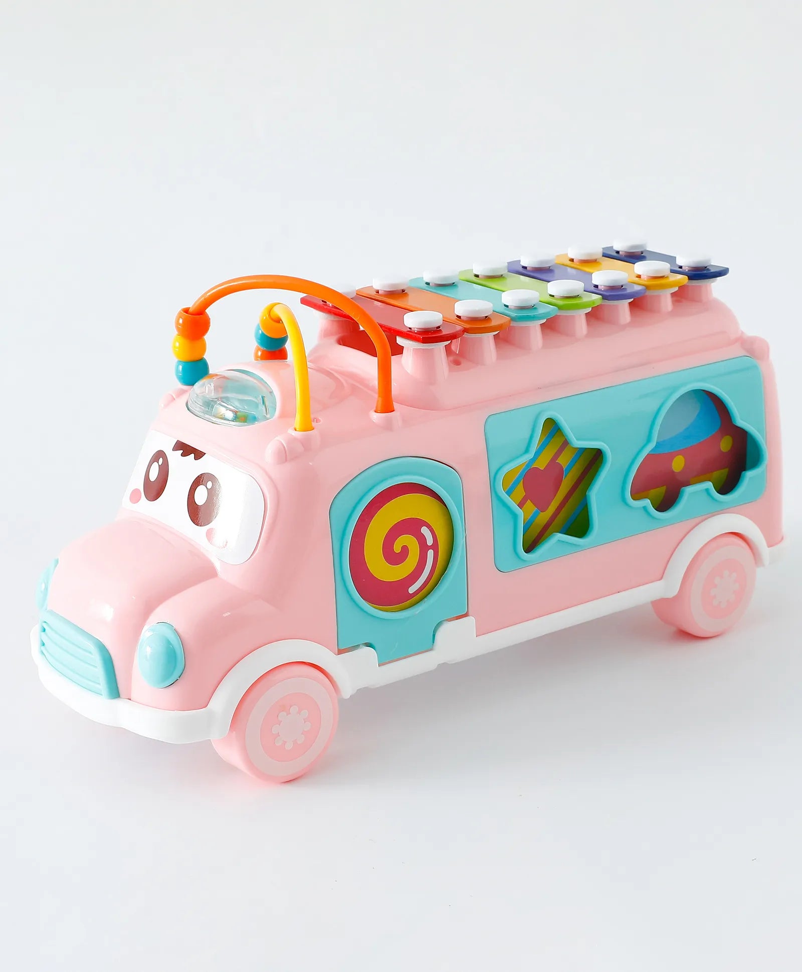 Pink musical shape matching bus toy with xylophone top, cute face design, and star and car sorting slots