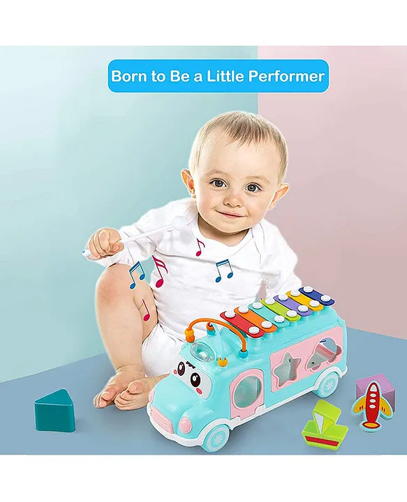 Baby playing with Musical Shape Sorting Bus with xylophone top and colorful matching blocks