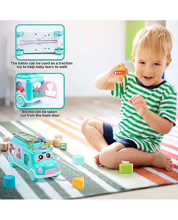 Child playing with Musical Shape Sorting Bus with pull rope and colorful blocks for matching play