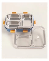 Open three-compartment stainless steel lunch box with transparent lid shown in a clean top view.